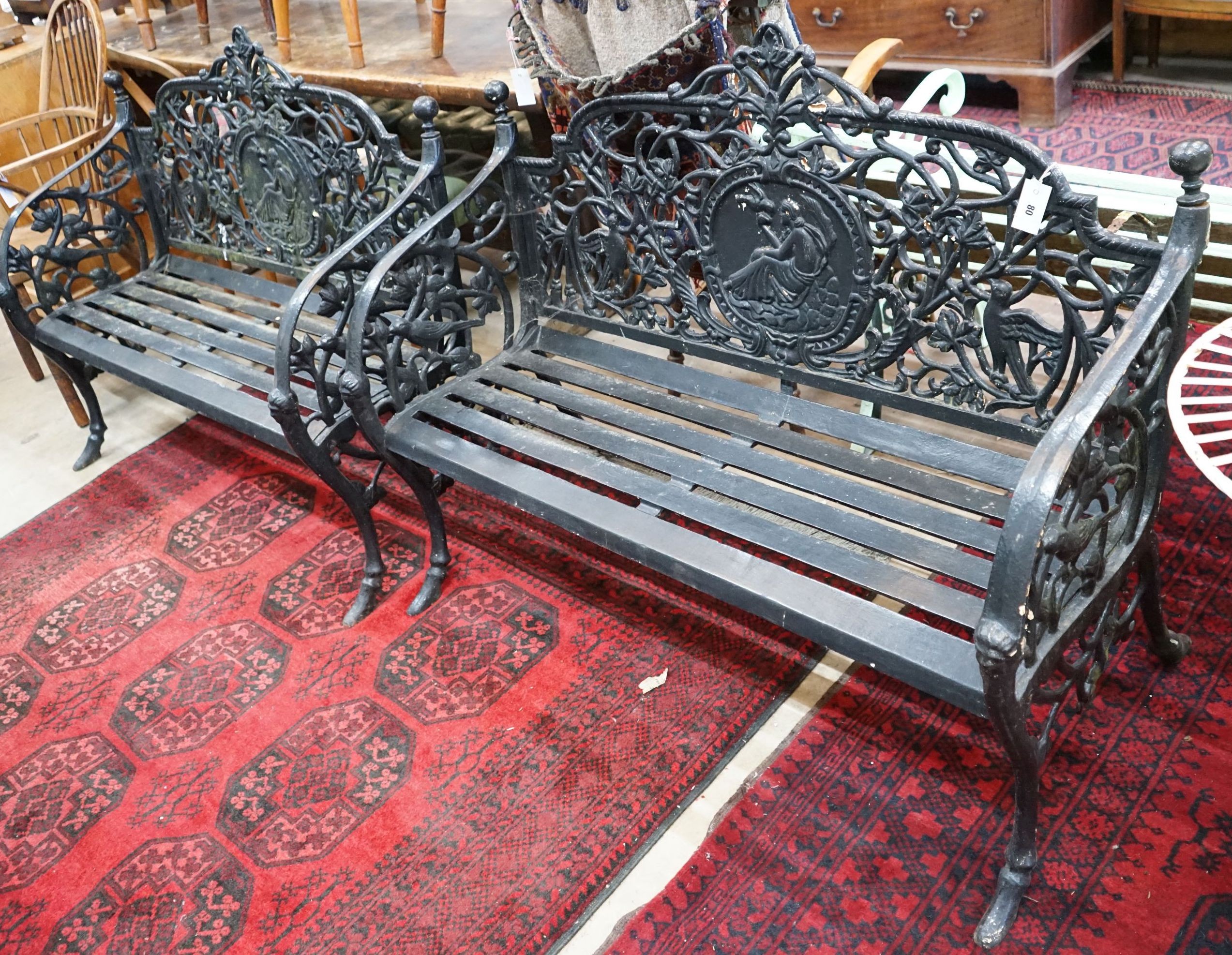 A pair of Victorian style painted cast iron garden benches, length 130cm, depth 44cm, height 97cm